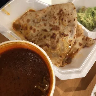 Birria-Chilada. I also got the birria beef consommé. Very good with the chopped onions, cilantro and lime.