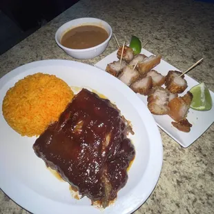 Barbecue pork ribs and Pork crackling with yellow rice and red beans.