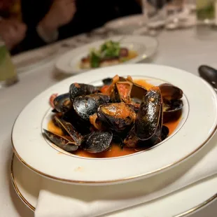 The steamed mussels with chorizo, tomatoes, shallots, white wine, and thyme.