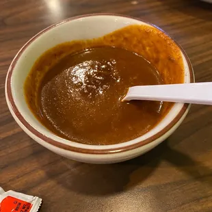 a bowl of soup with a spoon in it