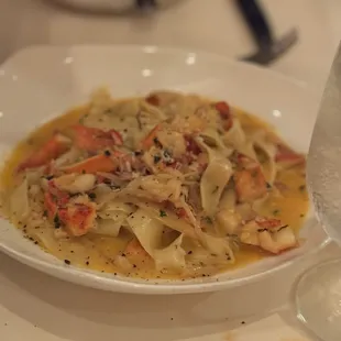 a plate of pasta and a glass of water