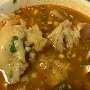 a bowl of soup with meat and vegetables