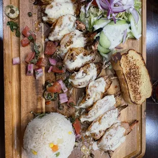 chicken, rice, and vegetables on a cutting board
