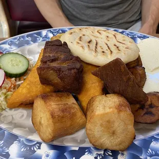 Breakfast of champions- pupusa, curtido, chicharrones, yucca, queso