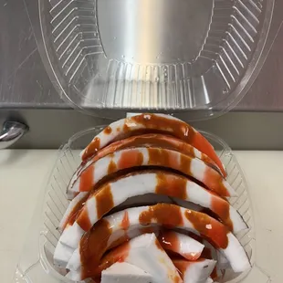 a clear plastic container filled with sauce