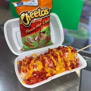 a container of cheetoes and a bag of chips