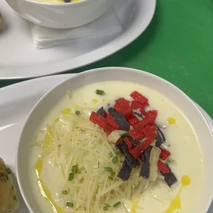 two bowls of soup on a green table