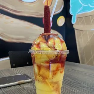 Large mangoneada - has mango pieces, Tajín, chamois, squirt of lemon juice