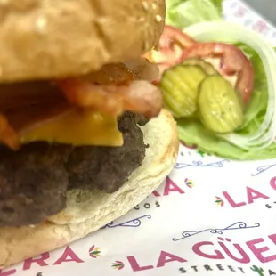 a cheeseburger with lettuce and tomato