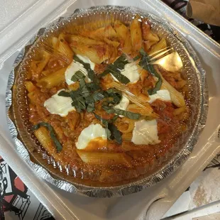 a pizza in a takeout container