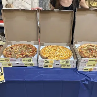 a woman holding a box of pizza