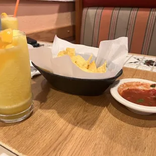 Chips and salsa with a non-alcoholic mango drink