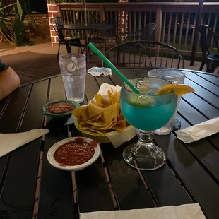 Delicious chips and salsa and blue margarita!! So nice out on the deck.