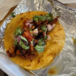 Al pastor on corn tortilla