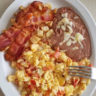 Mexican eggs with potatoes and beans with an added side of bacon
