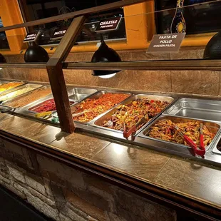 a variety of food in a buffet