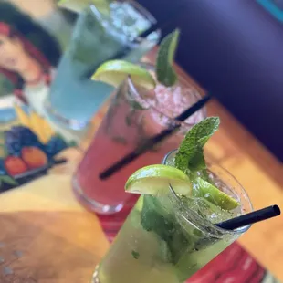 three cocktails on a table