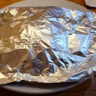 Tacos served under aluminum foil to keep warm