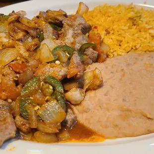 Steak ala Mexicana served with refried beans and rice