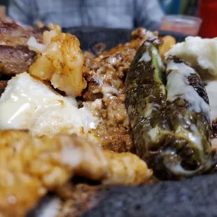 Mocajete with chorizo, steak, chicken, and shrimp with some cheese.   Waaaaaay to salty for me.