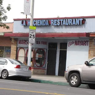 two cars parked in front of a restaurant