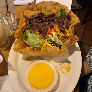 On a hot summer day a great fajita salad and a cold margarita to help me to enjoy the Texas Heat .