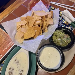 Queso, guacamole, complementary chips and salsa