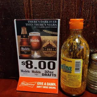 a bottle of beer next to a sign