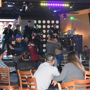 a group of people sitting around a bar