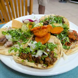 Plate of tacos, warning they give you two salsas one of them can be very spicy.
