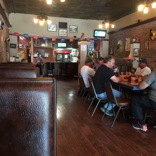 people sitting at tables in a restaurant