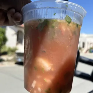 a hand holding a drink