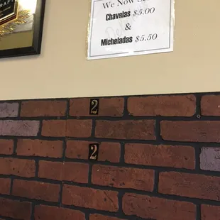 a sign on a brick wall