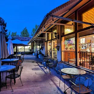 a patio with tables and chairs