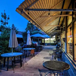 a patio with tables and chairs