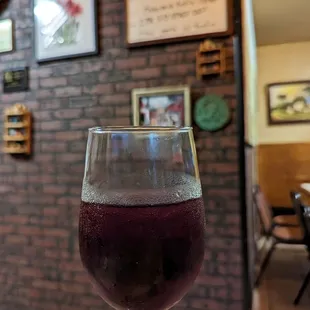 a hand holding a glass of wine