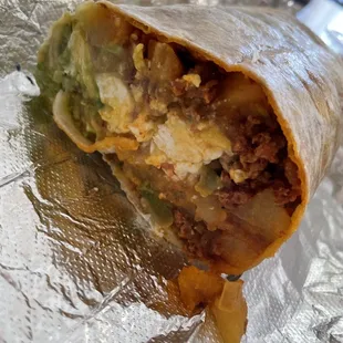 Chorizo breakfast burrito, comes w/ guacamole and potatoes!