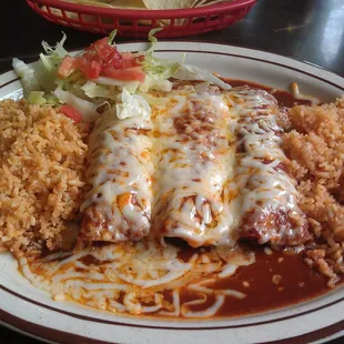 Chicken enchiladas with red sauce and double rice.