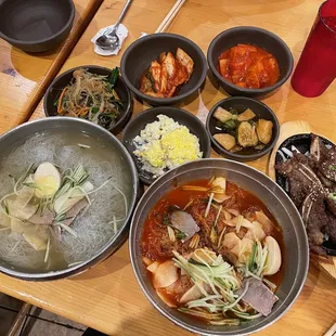 a variety of dishes on a wooden table