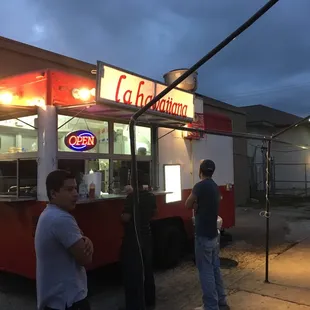 people standing in front of a food truck
