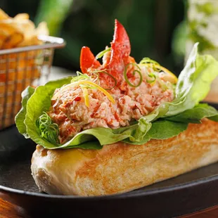 a lobster sandwich with lettuce and chips