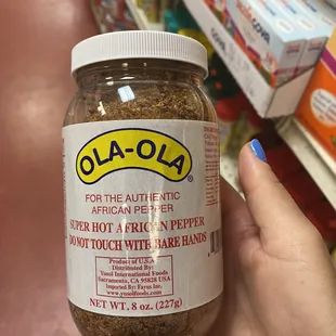 a hand holding a jar of food