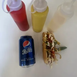 a can of pepsi, mustard, and ketchup