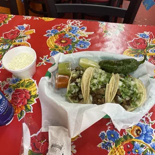 3 steak tacos with queso fresco on side and grilled jalapeño. Super good!!! Fresh and hot.