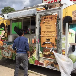 a man standing in front of a food truck