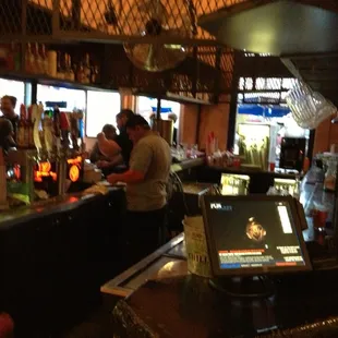 a man sitting at a bar with a laptop