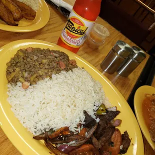 a plate of rice, beans, and meat