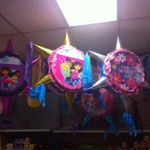 a bunch of balloons hanging from the ceiling