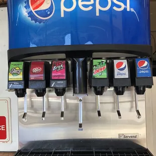 a soda dispenser and a pepsi machine