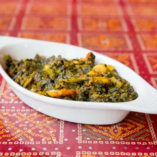 a bowl of spinach and potatoes